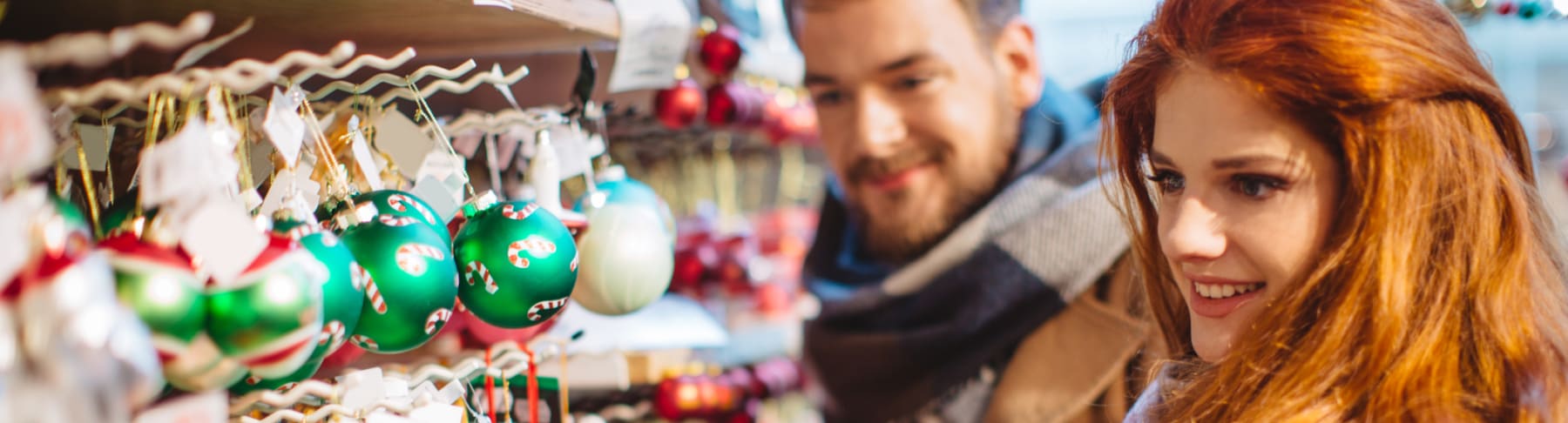 Man and woman shop for Christmas ornaments.