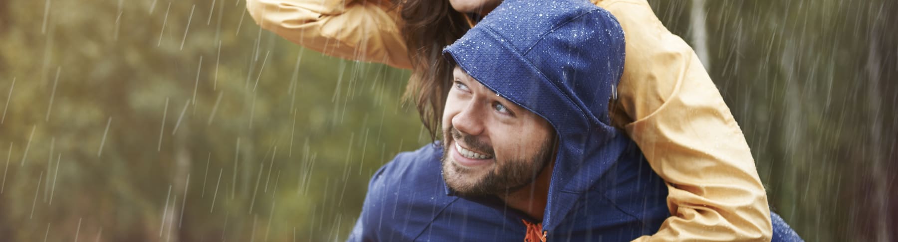 Man and woman enjoy the rain.