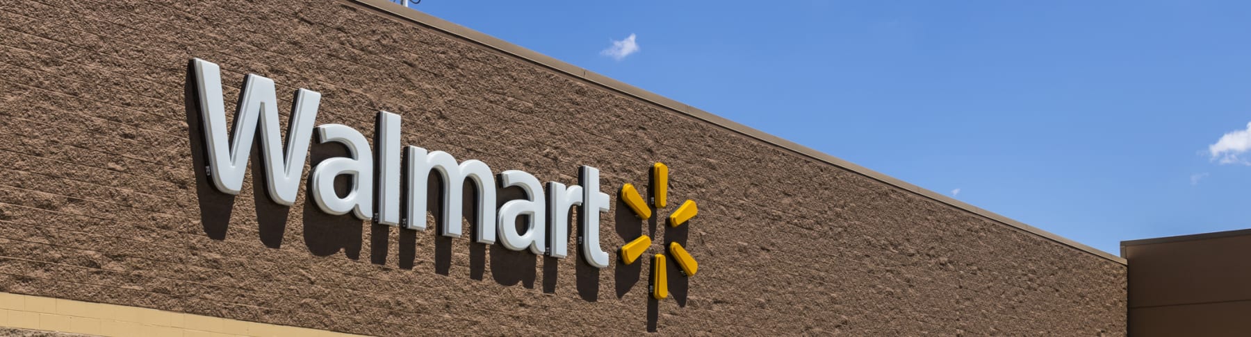 Walmart store sign shown in daytime.