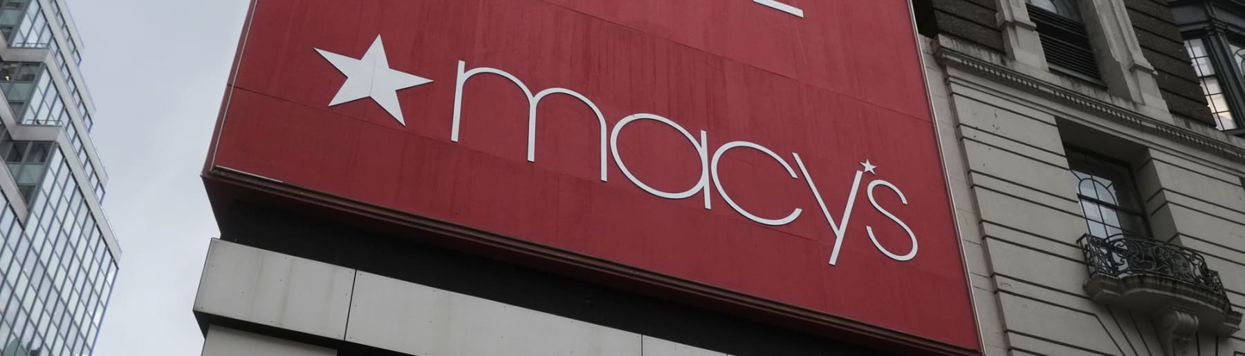 Red and white Macy's sign shown on side of building.