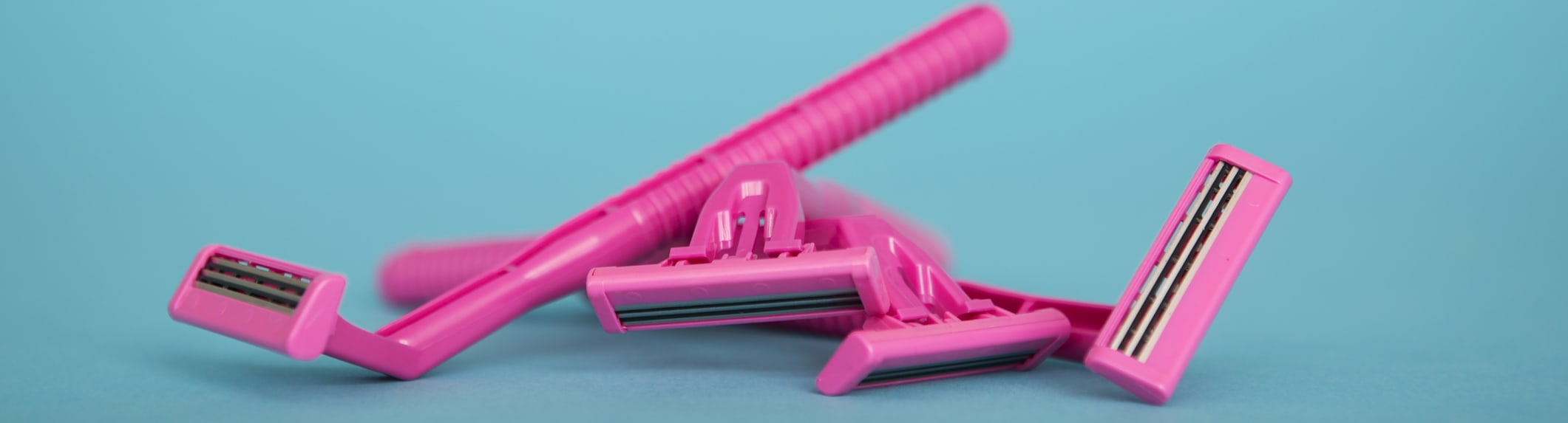 Pink razors on a blue background