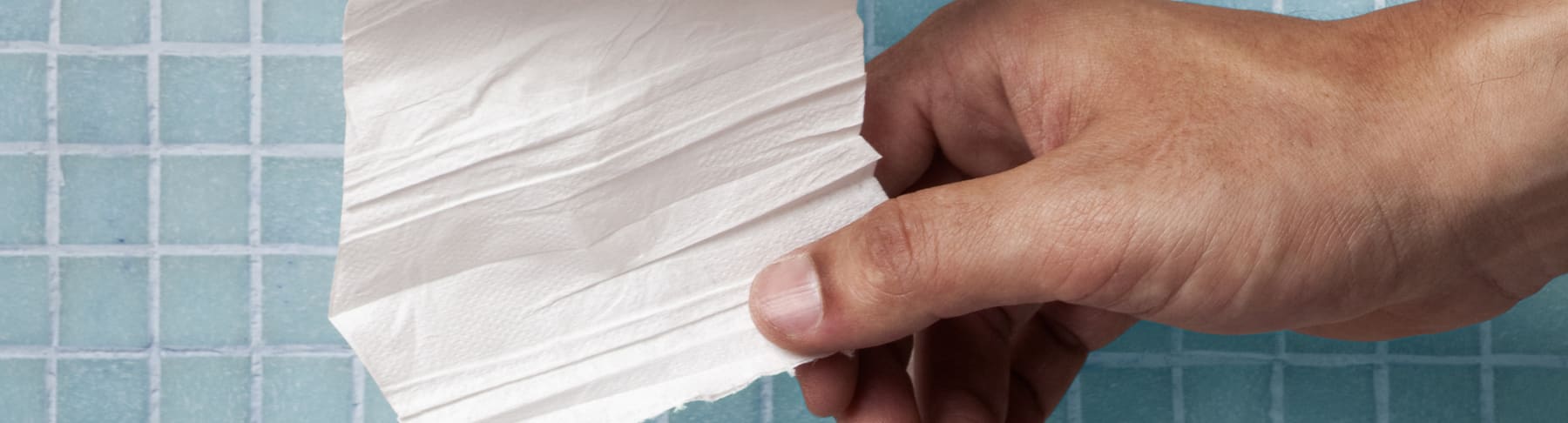 hand grabbing toilet paper