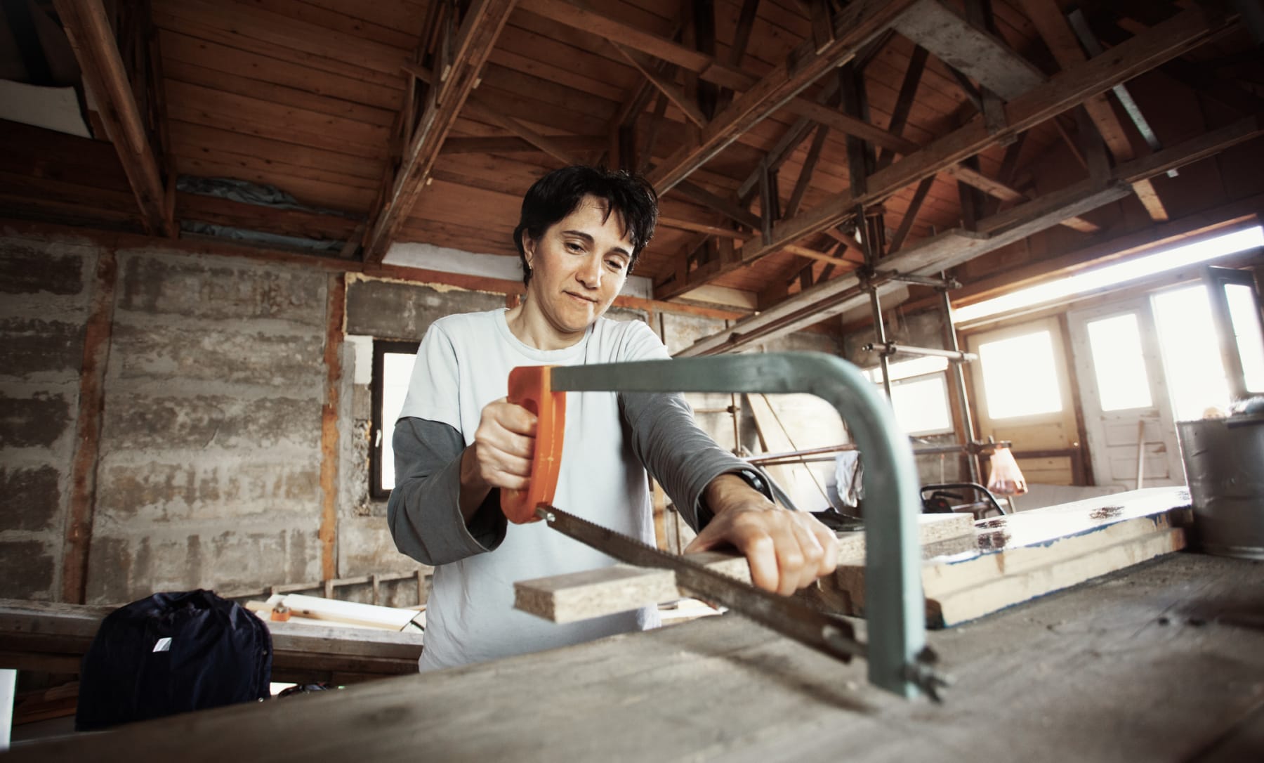 Woman Using Hand saw