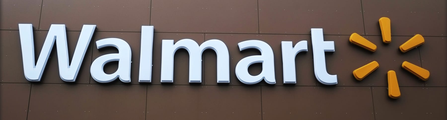 Walmart sign hangs on store.