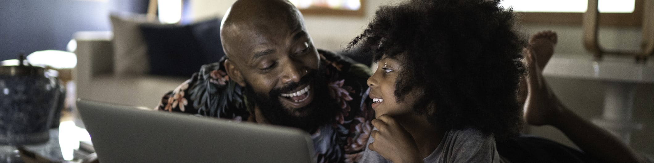 dad and daughter watching video