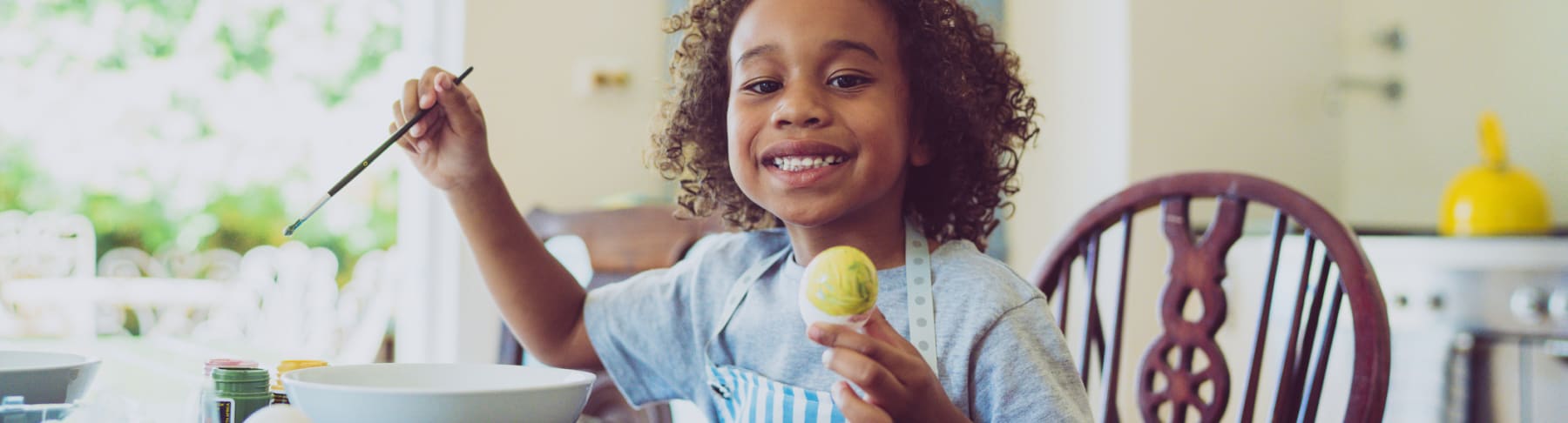 Child decorating Easter eggs.