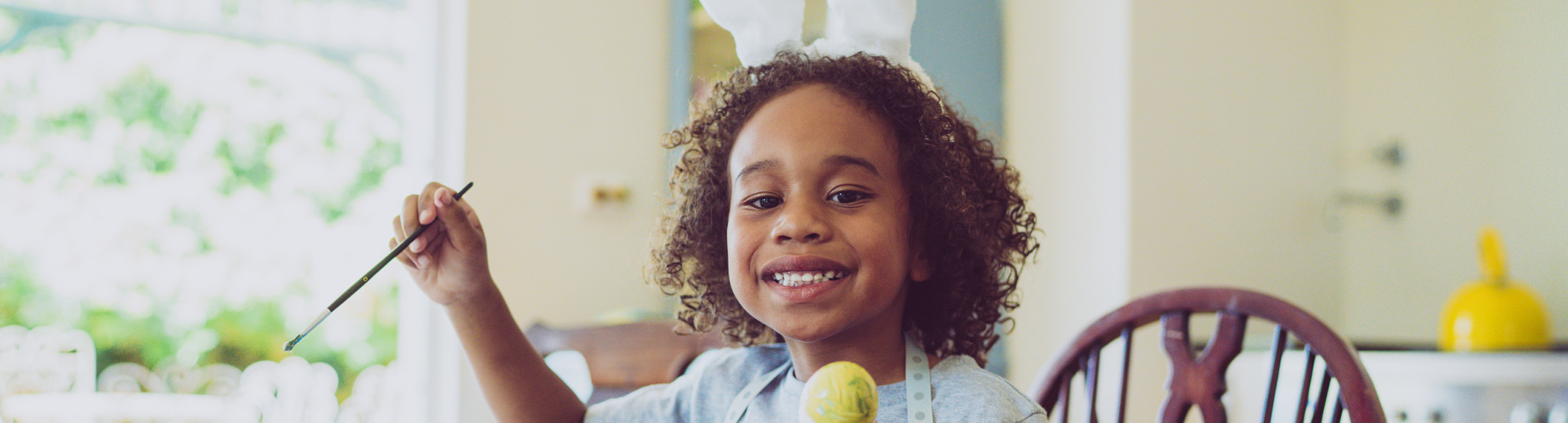 smiling child with Easter eggs