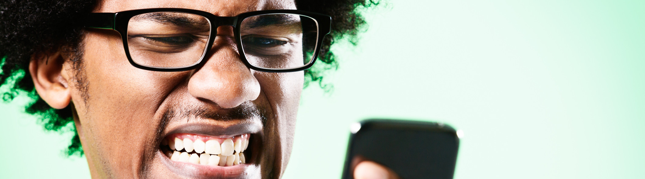 Man wincing at phone