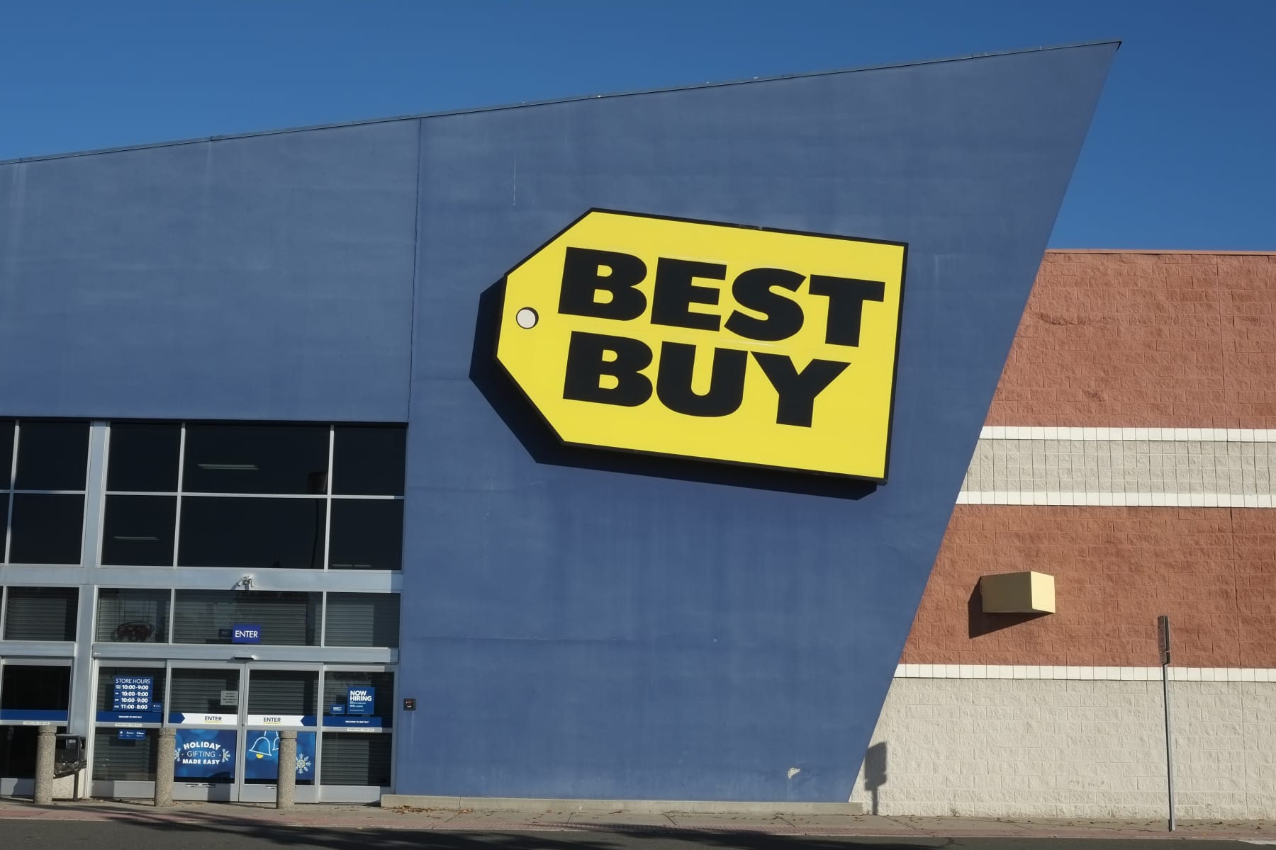 A Best Buy sign hangs on a store