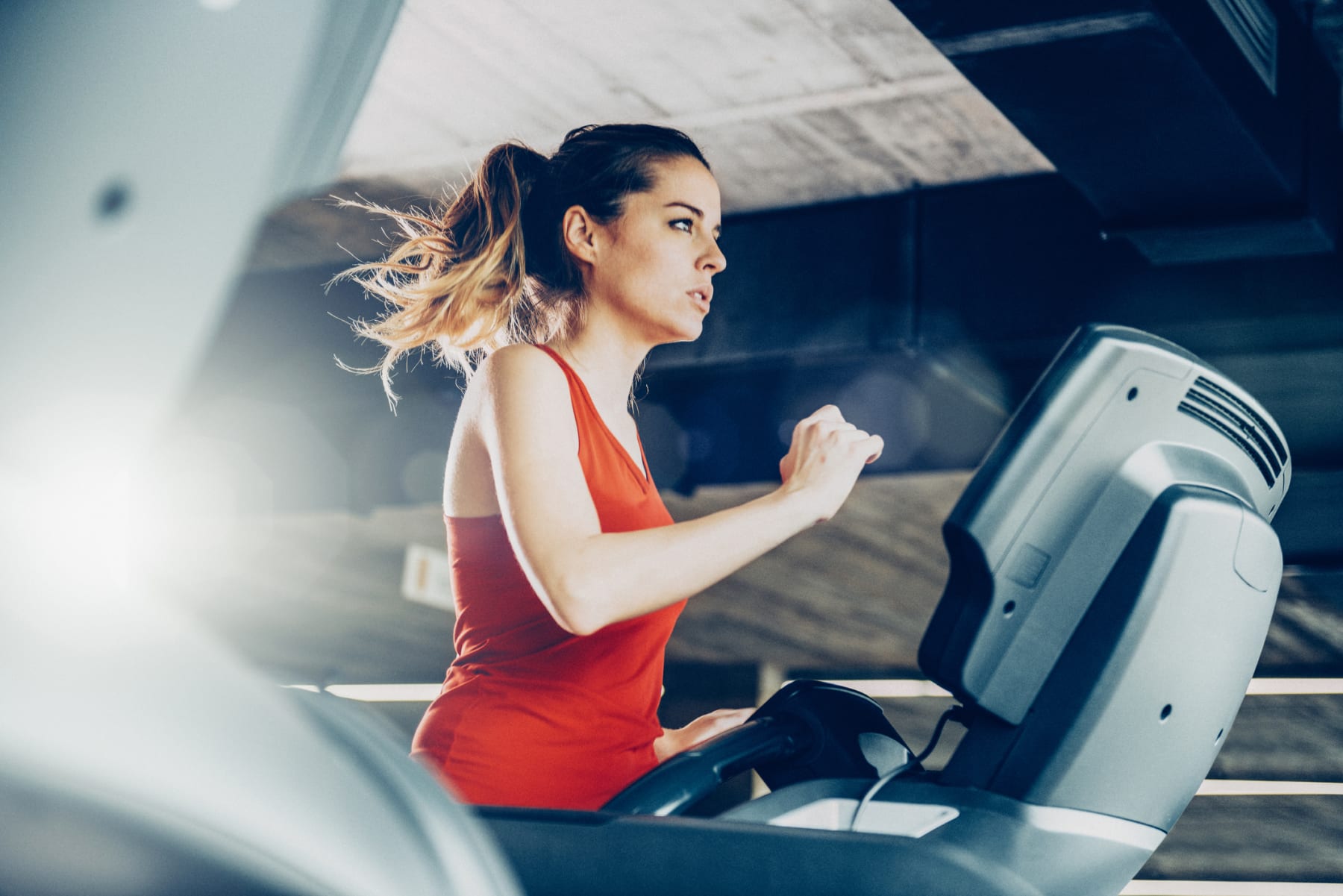 Woman runs on treadmill.