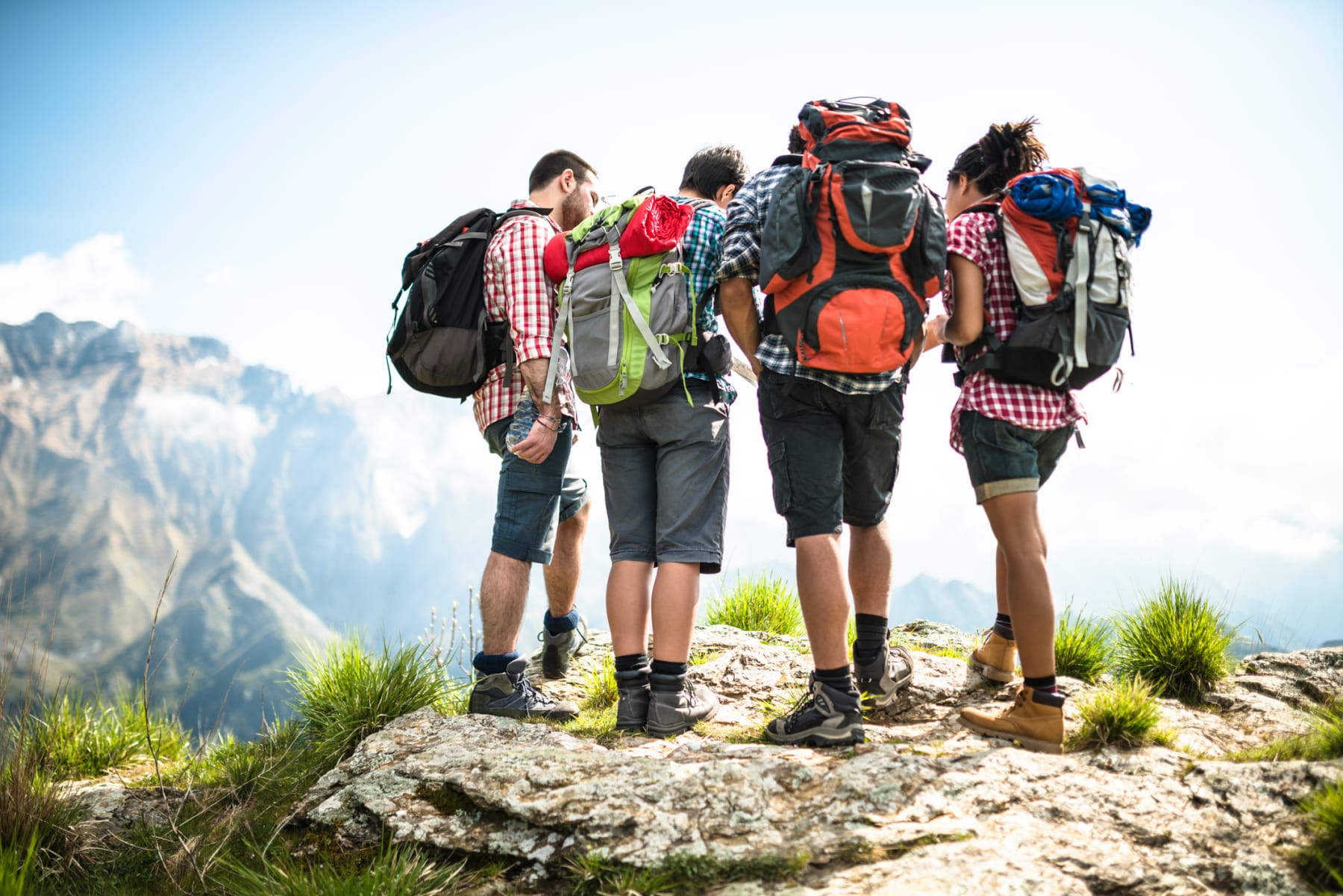 A group of hikers wearing backpacks outdoors.