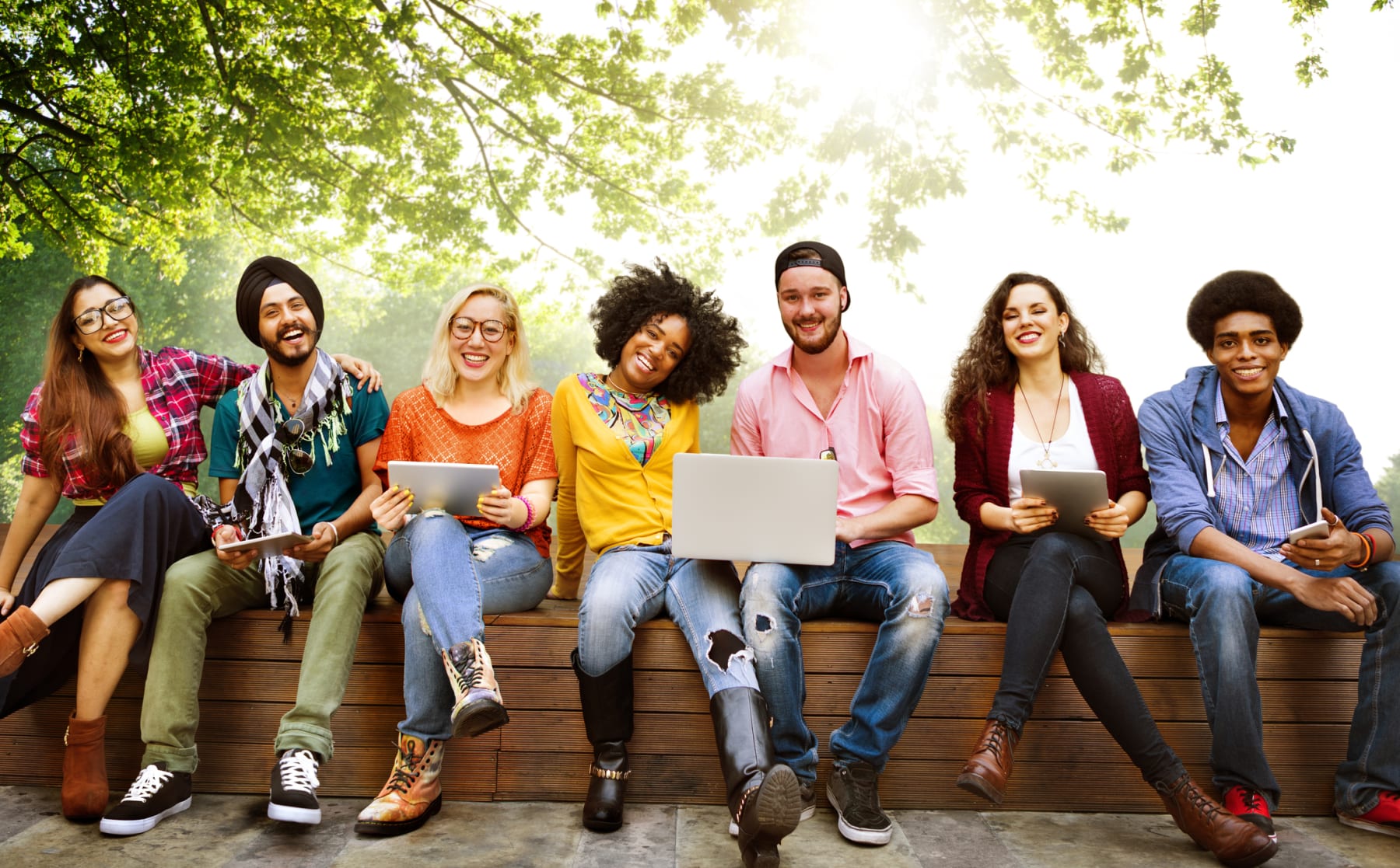 College students sit together on a bench.