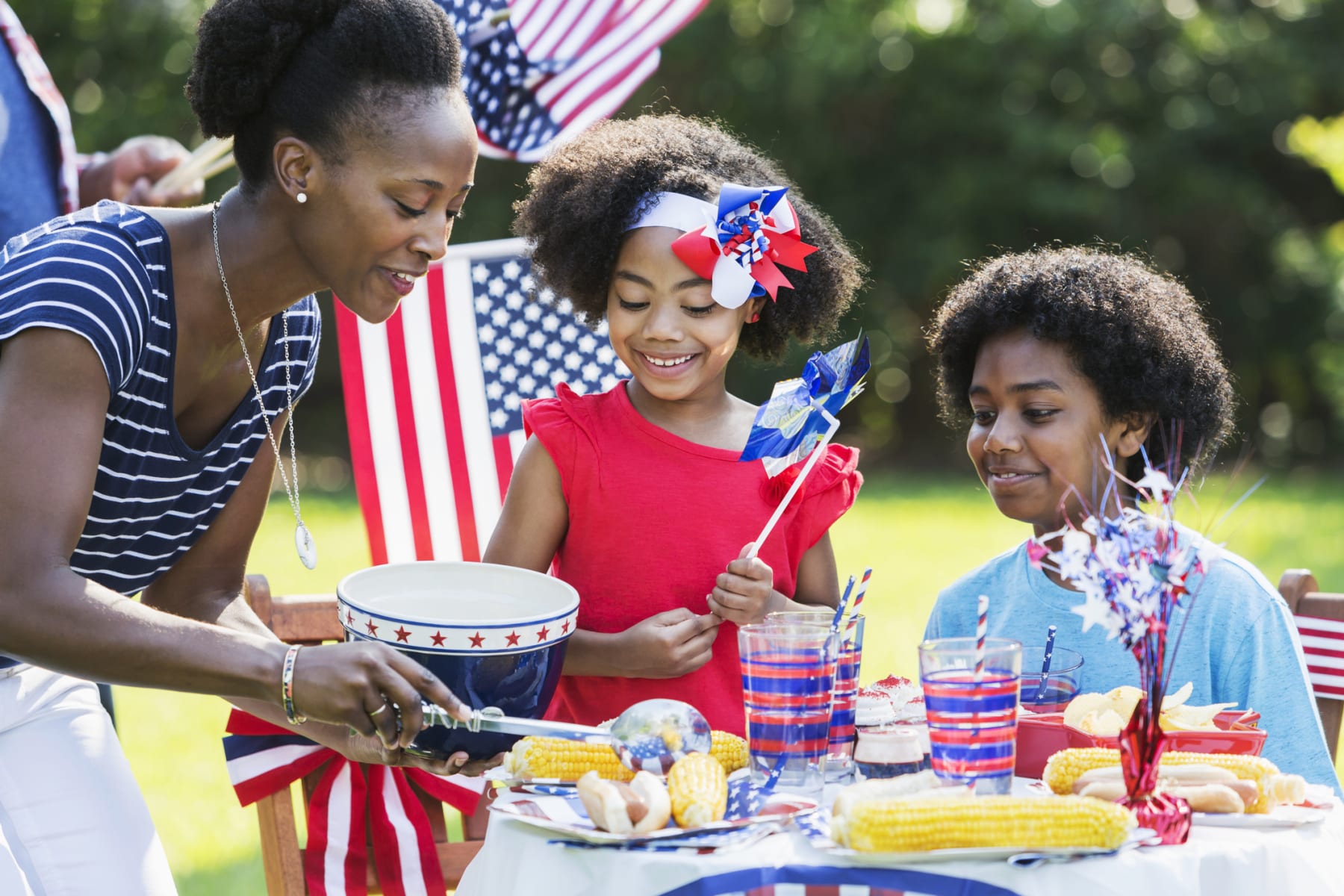 Woman and children attending a national holiday picnic.