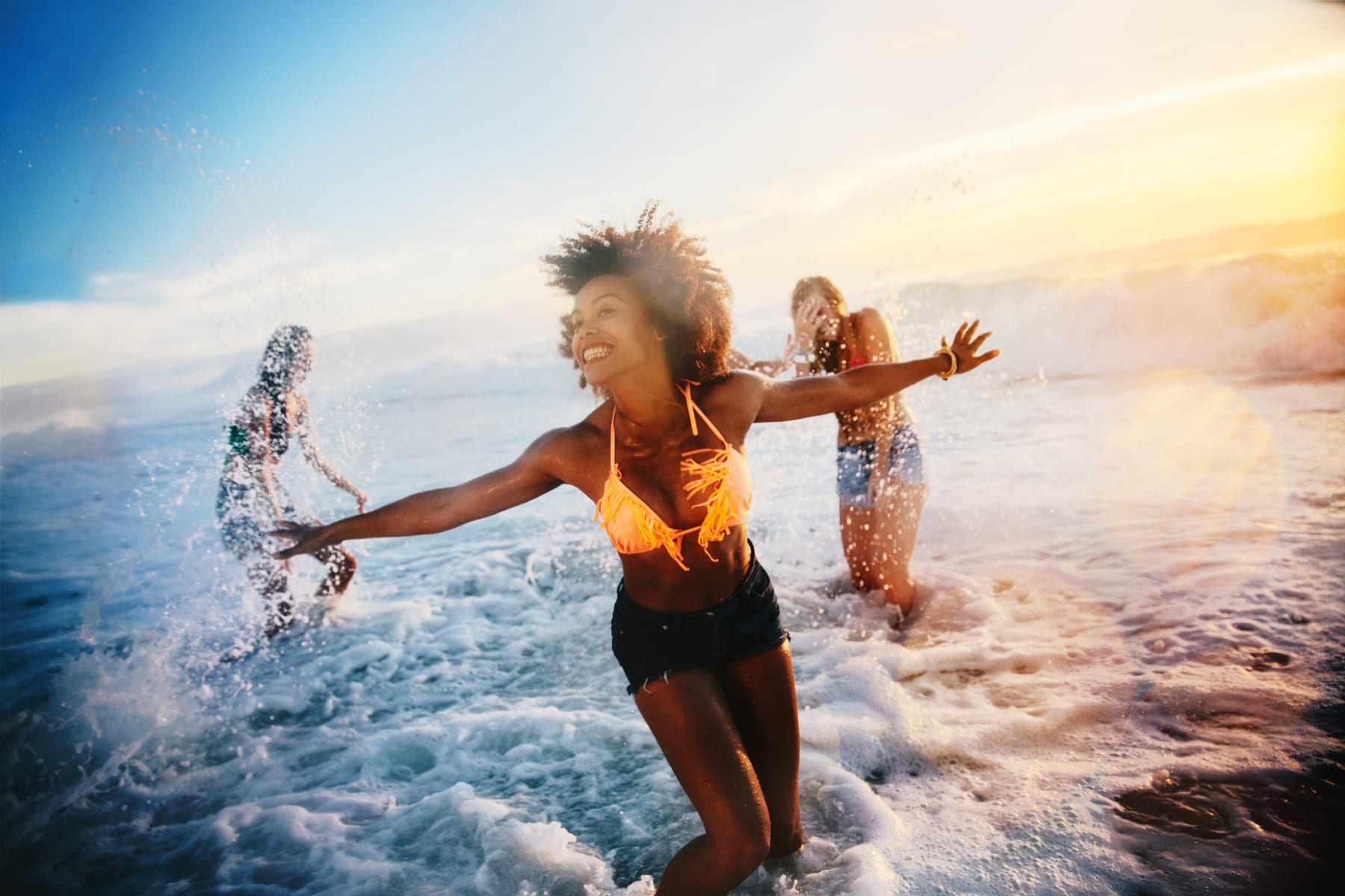 Women play in water at the beach.