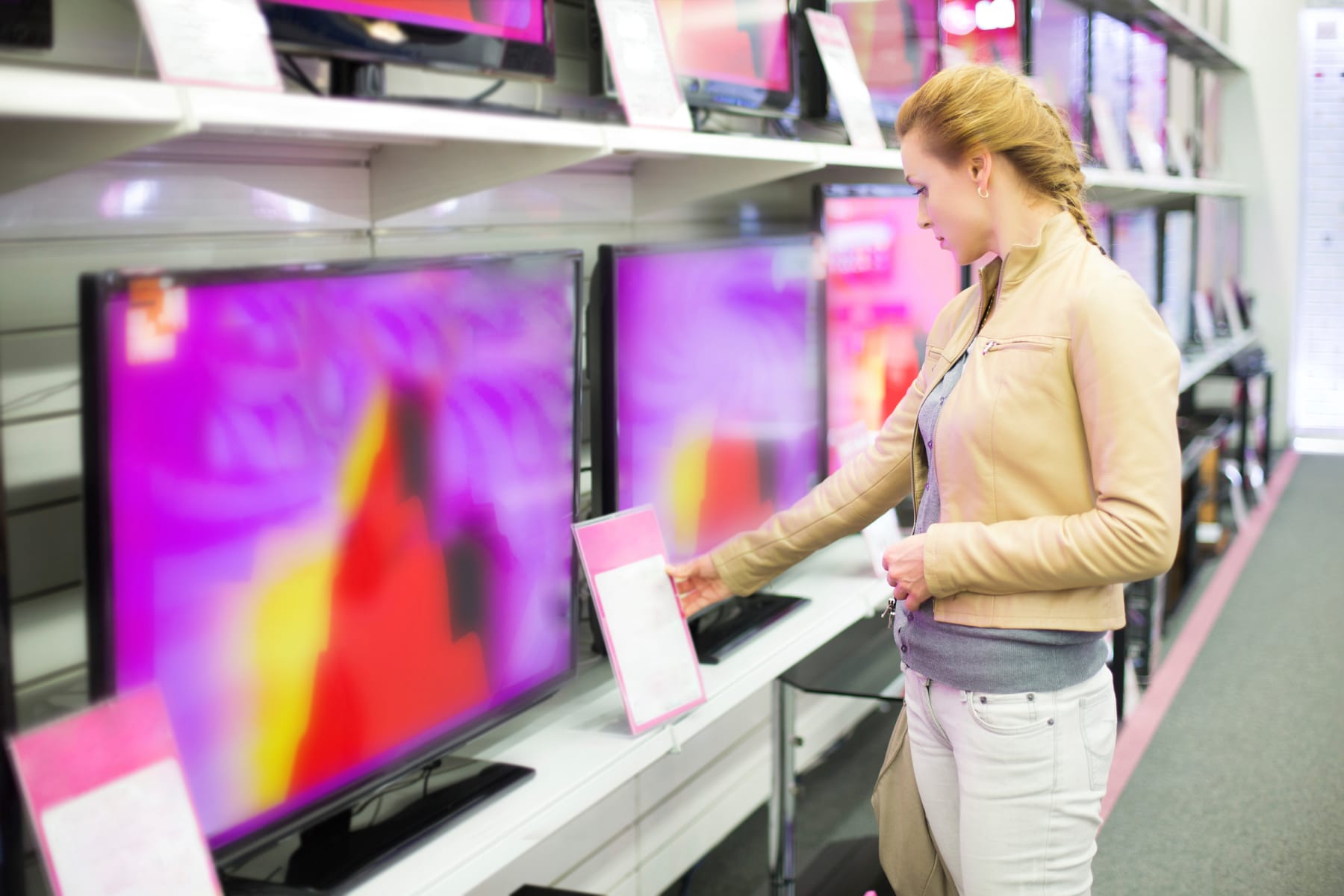 Woman studying TV price tags.