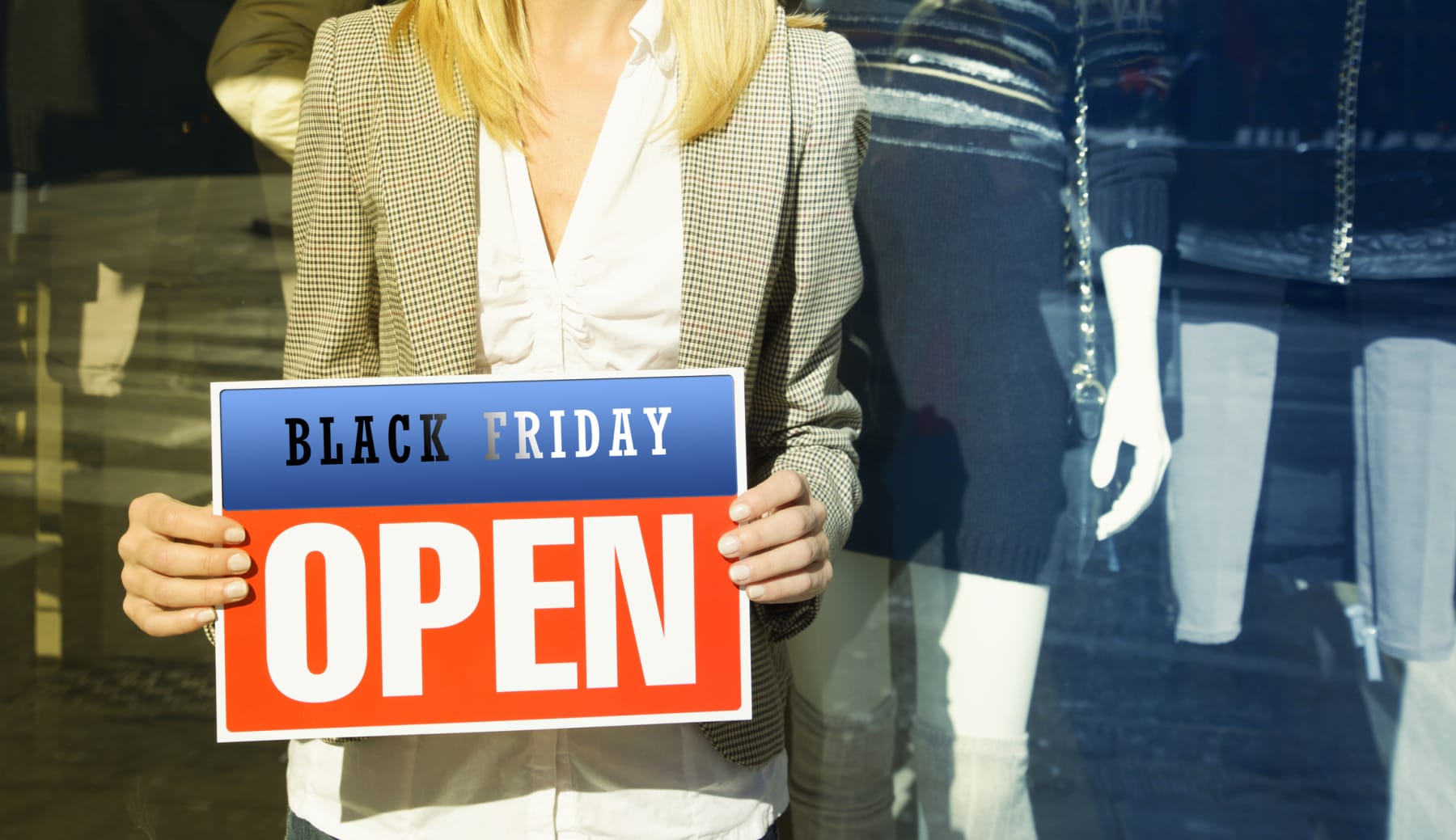Woman holds Black Friday Open sign.