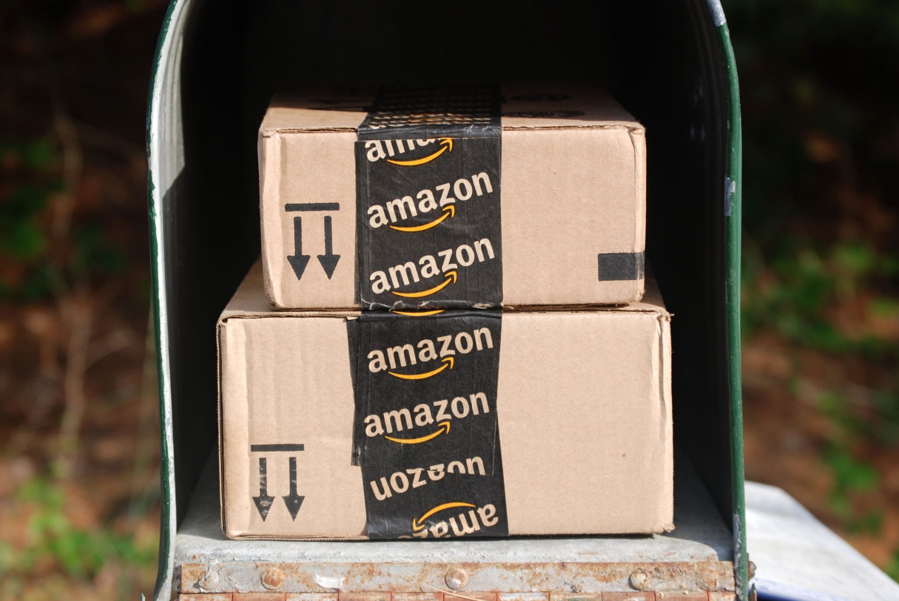 Two Amazon packages are stacked in mailbox.