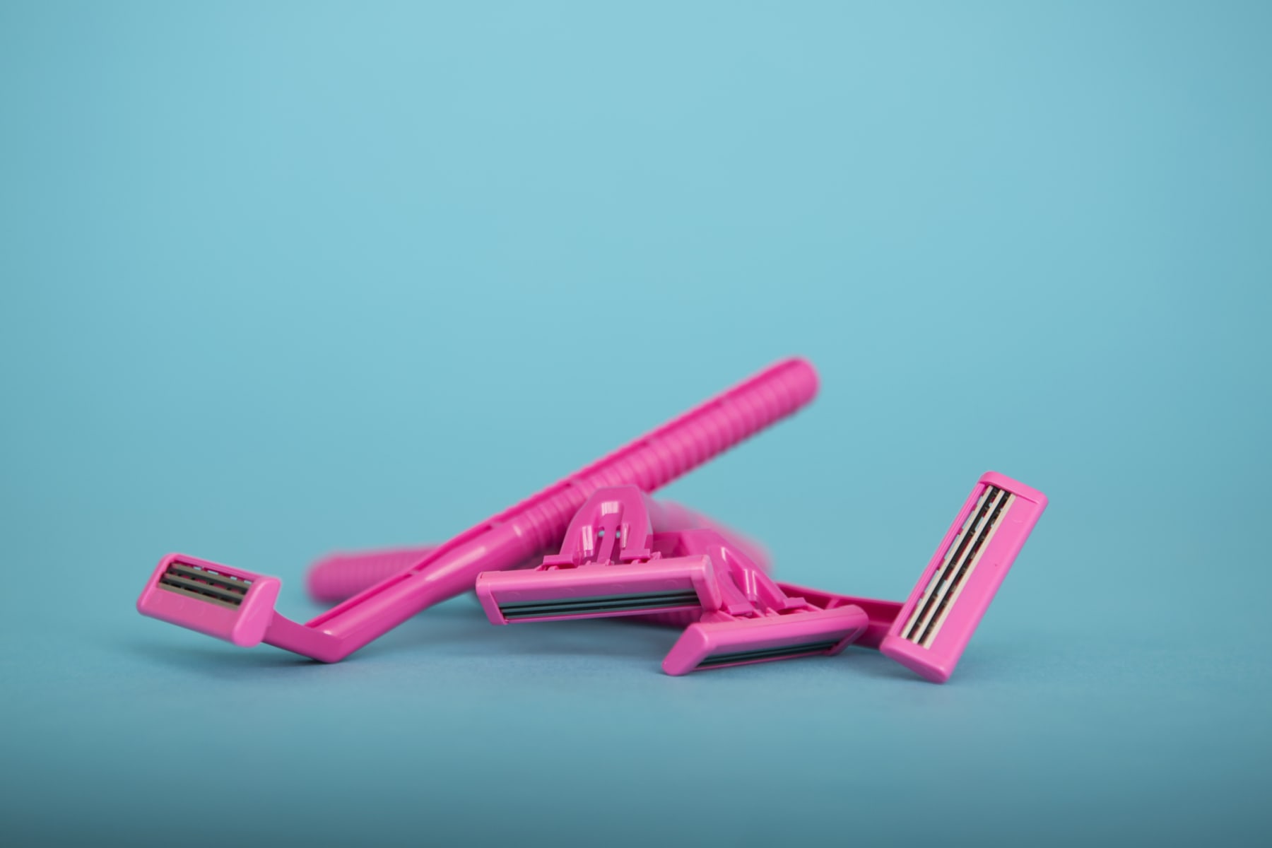 Generic pink razors shown in a pile.