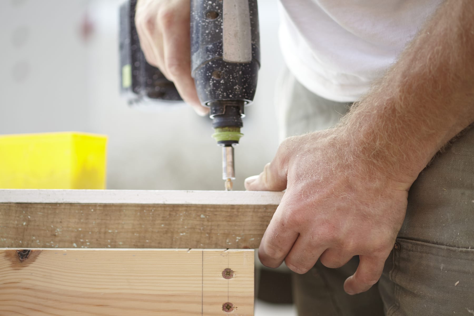 person using cordless drill