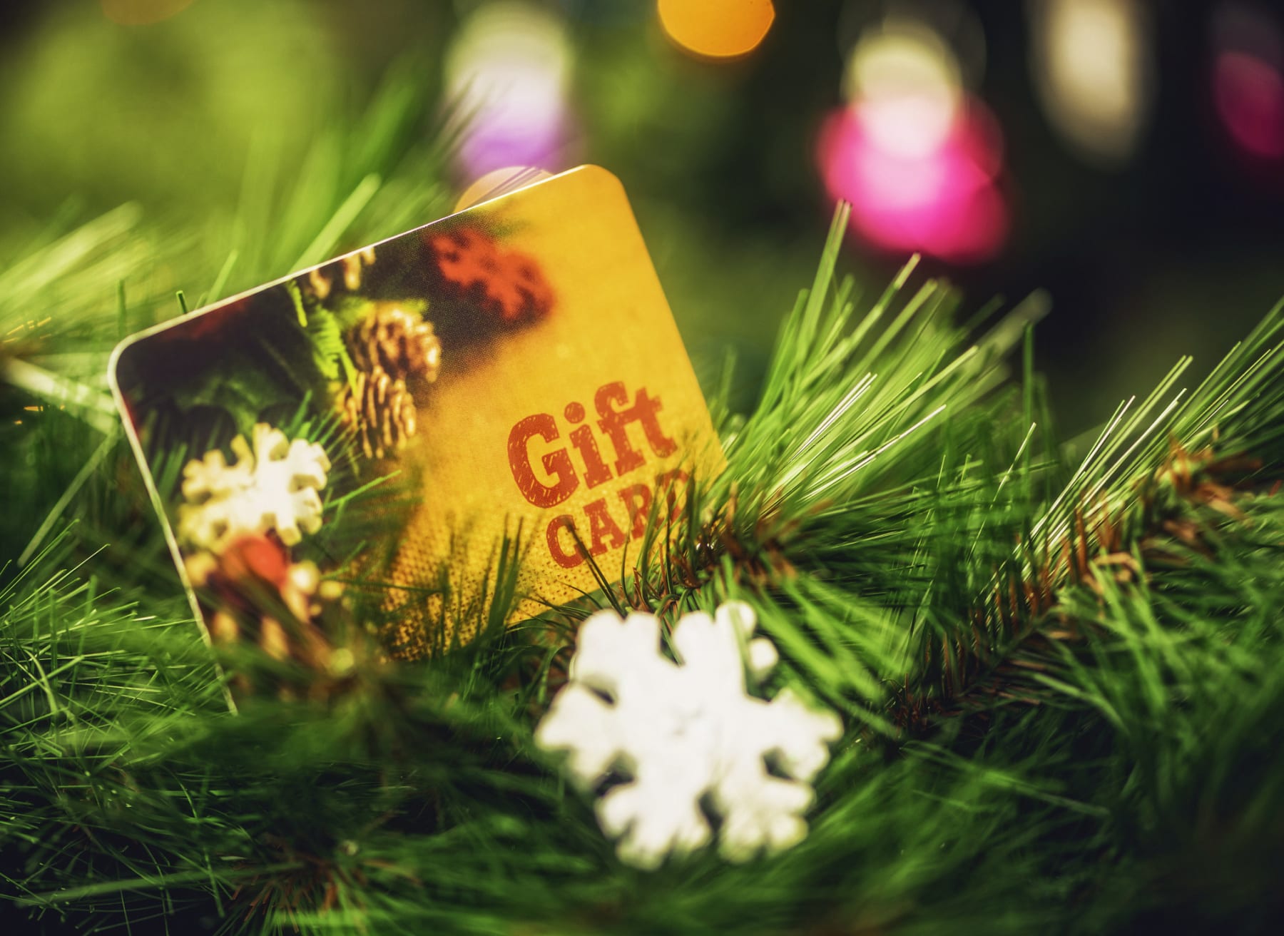 Gift card sits on Christmas tree.