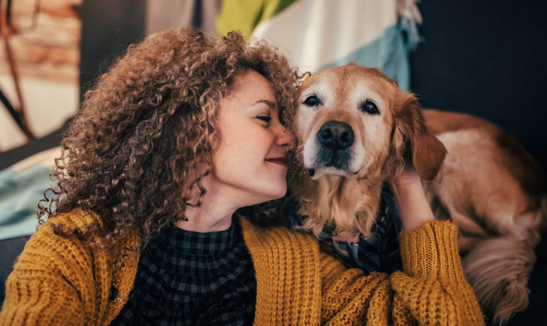 woman cuddles dog
