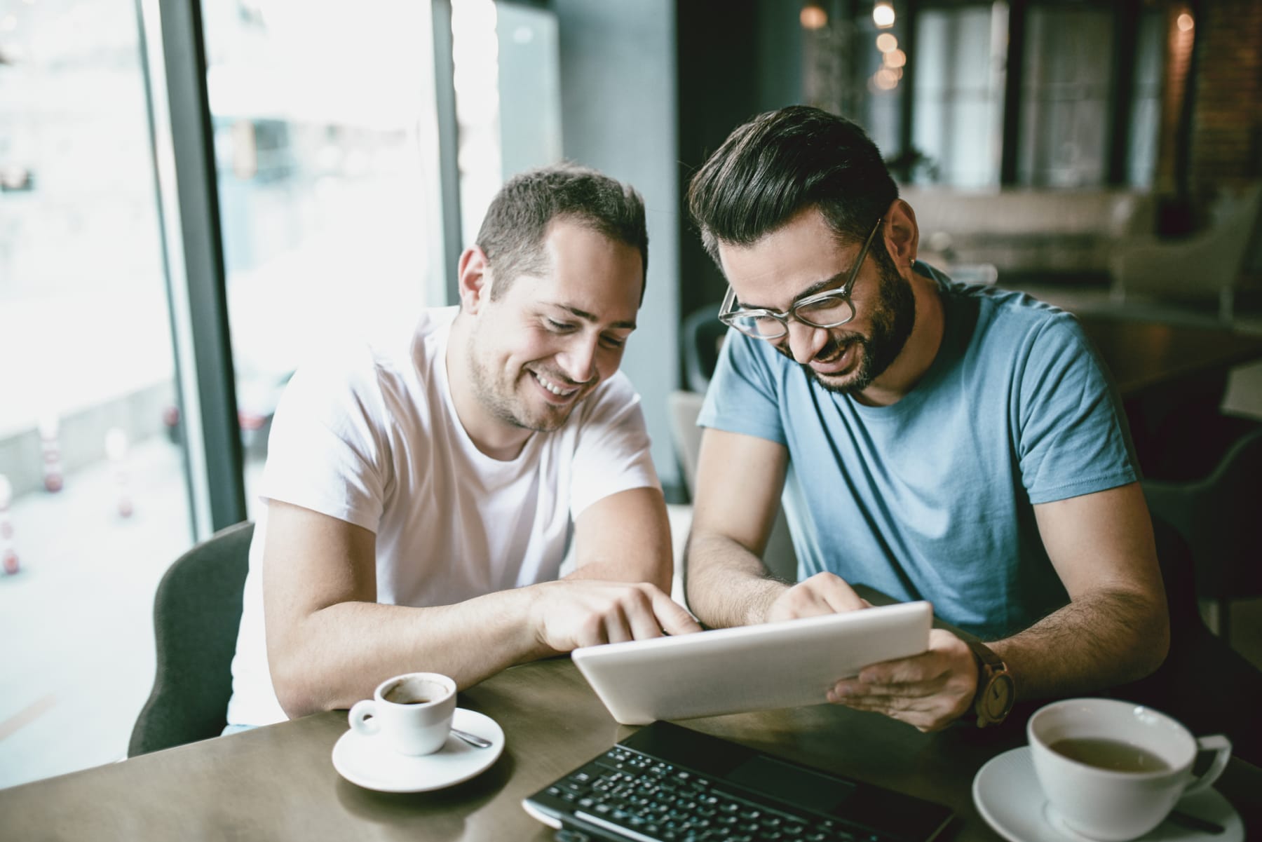 men staring at tablet