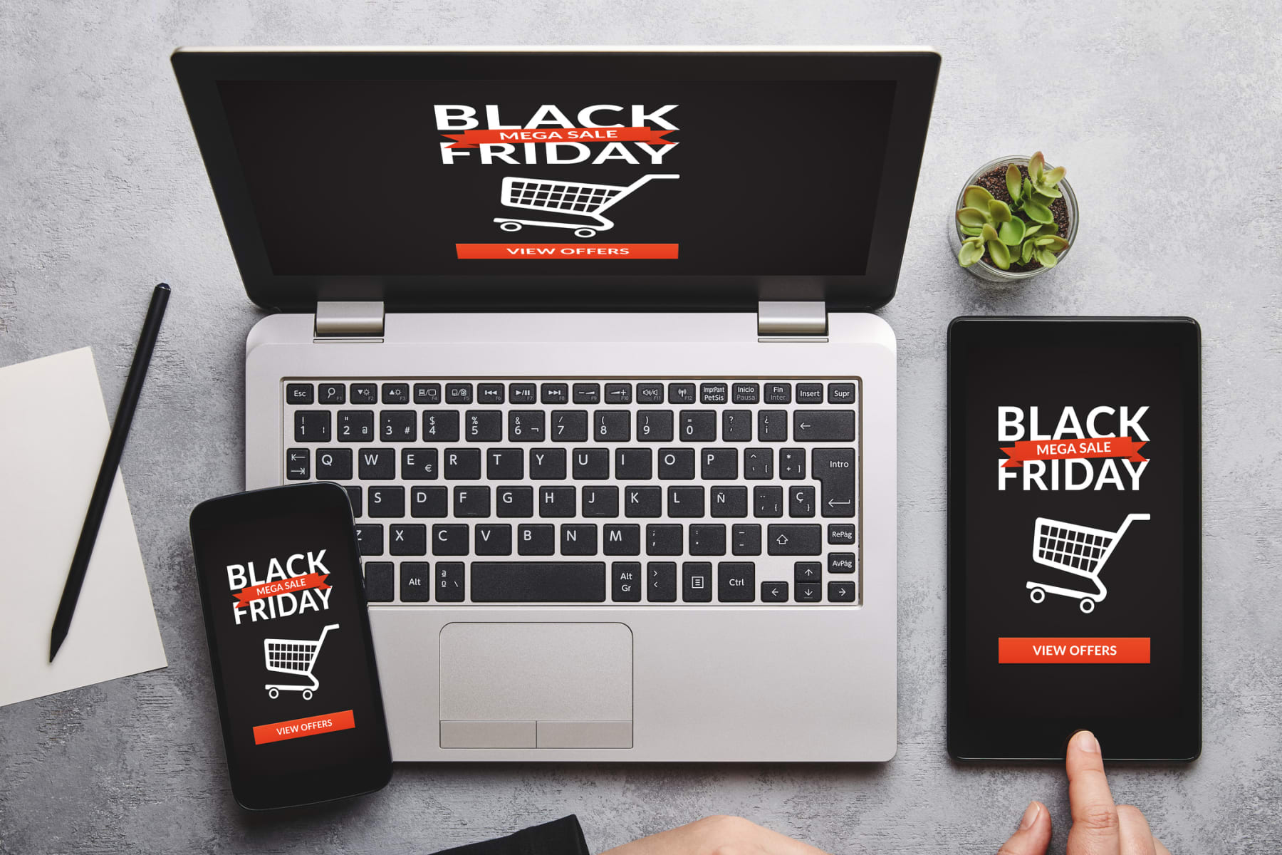 Black Friday ads appear on a laptop, smartphone, and tablet.