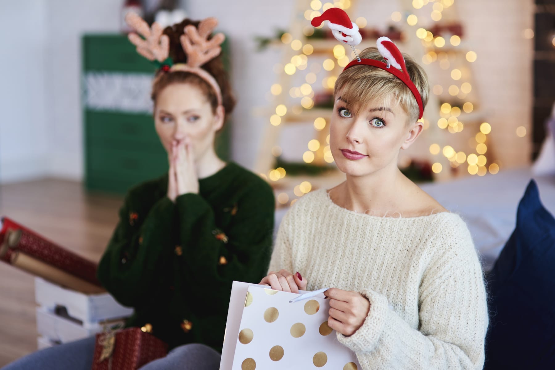 Woman looking unhappy about holiday gift.