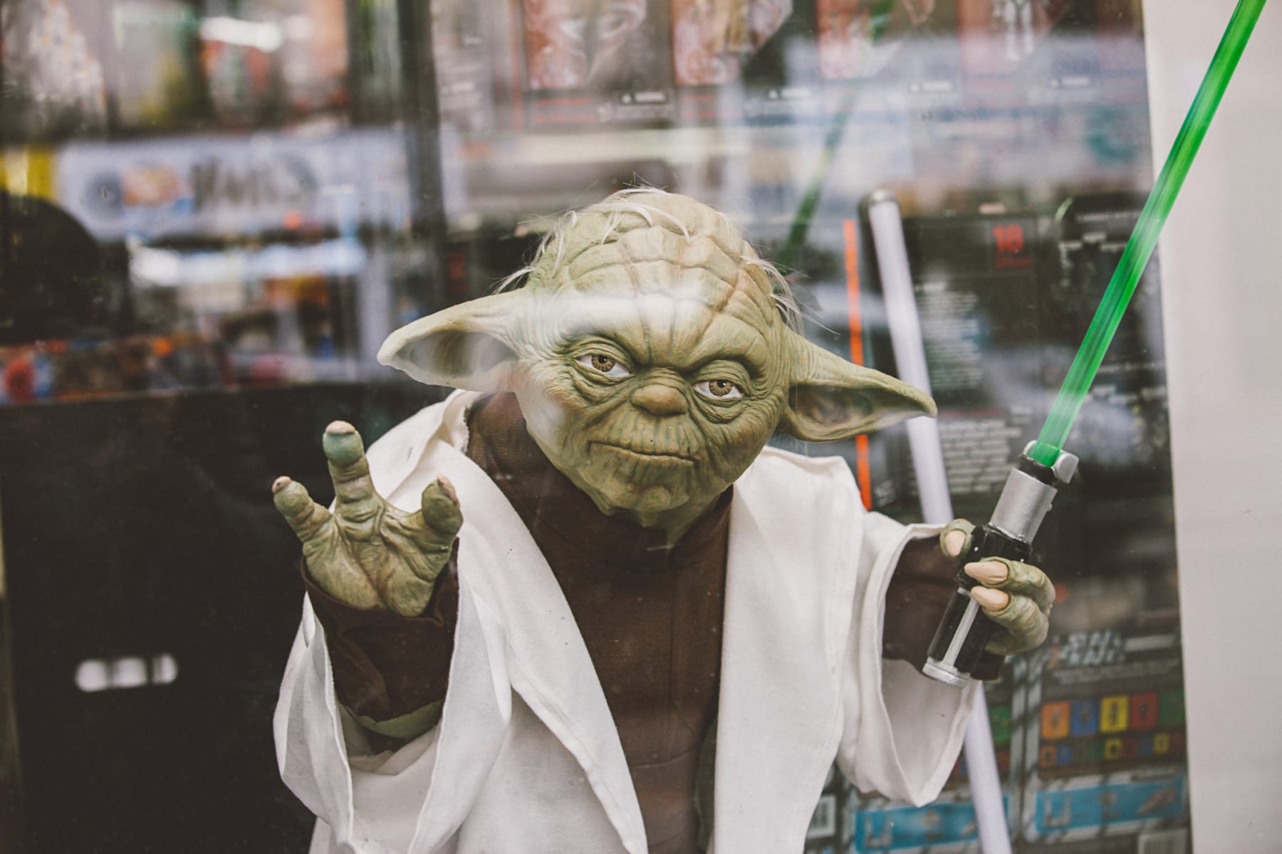 Toy model of Star Wars character Yoda featured in window display.