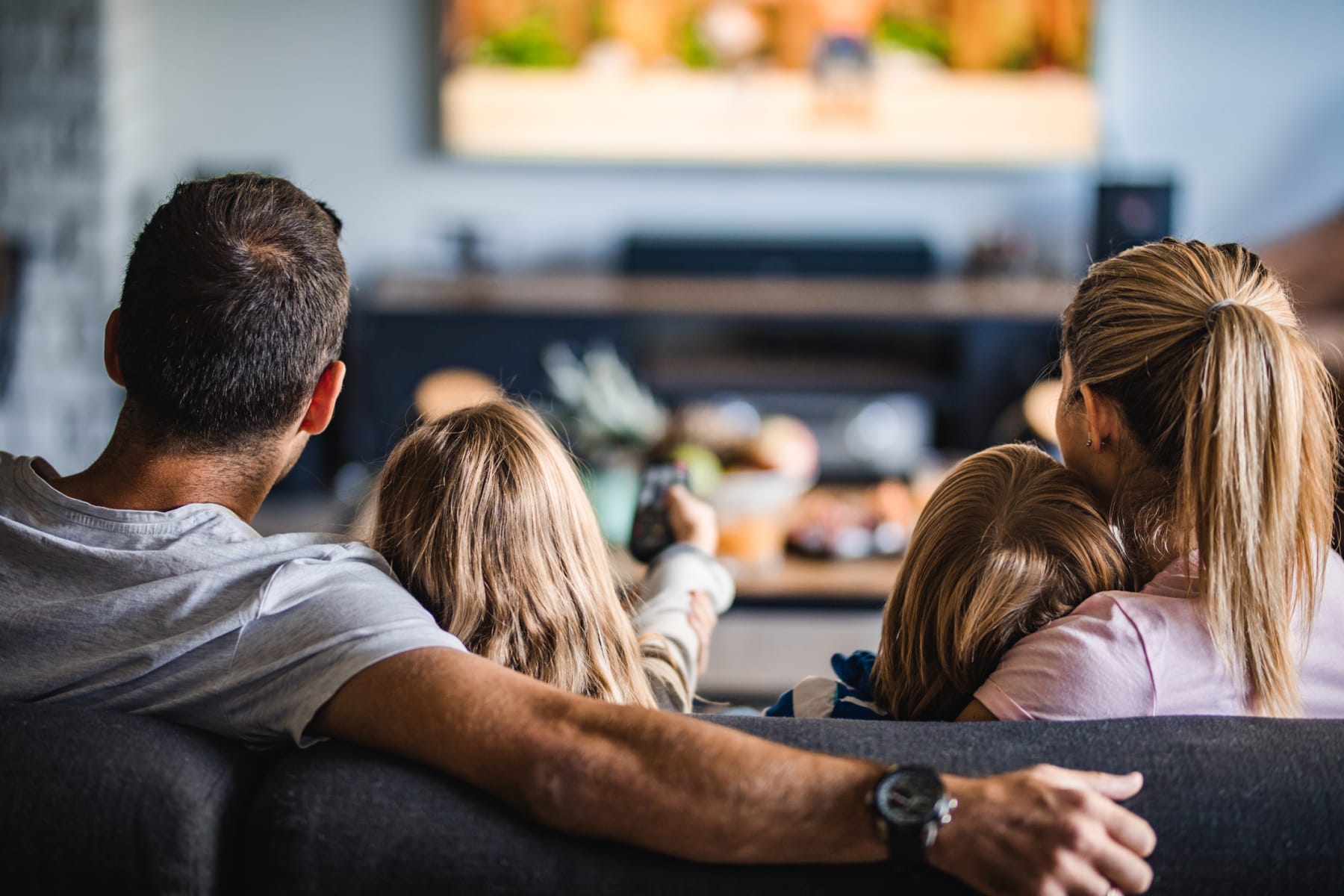 Family watches TV together.