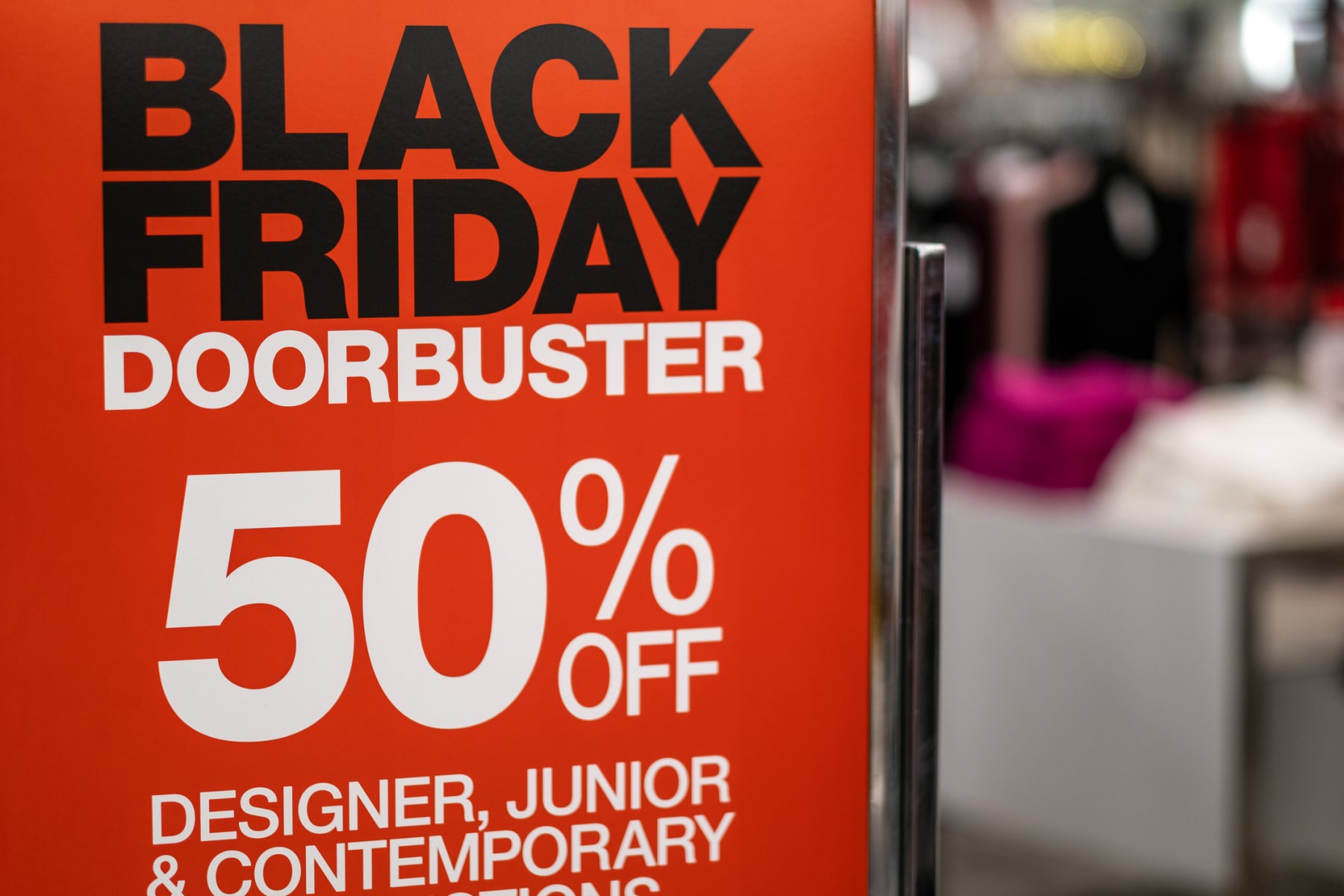 Black Friday doorbuster sign displayed at department store.