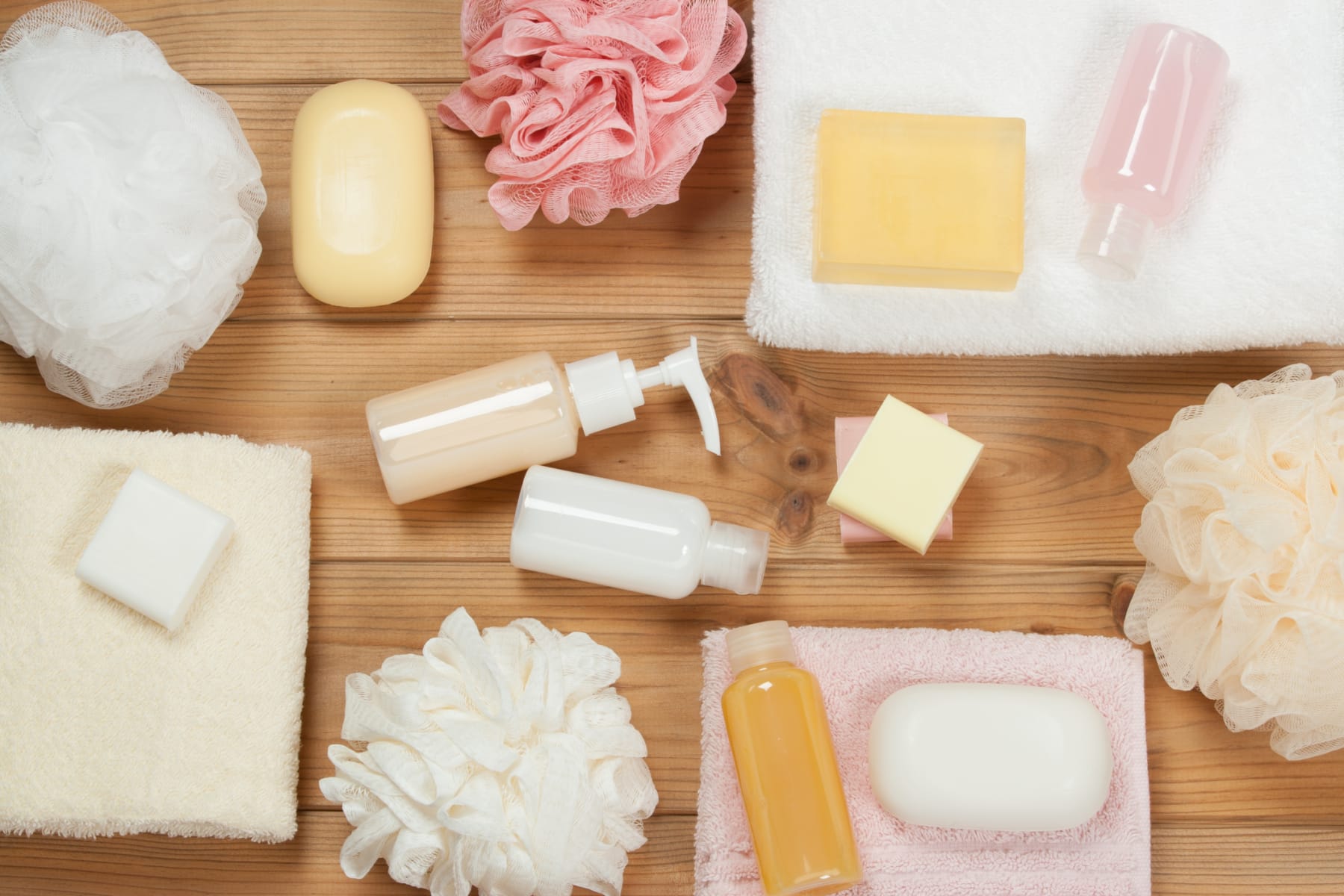 Personal care products displayed on a wood surface.