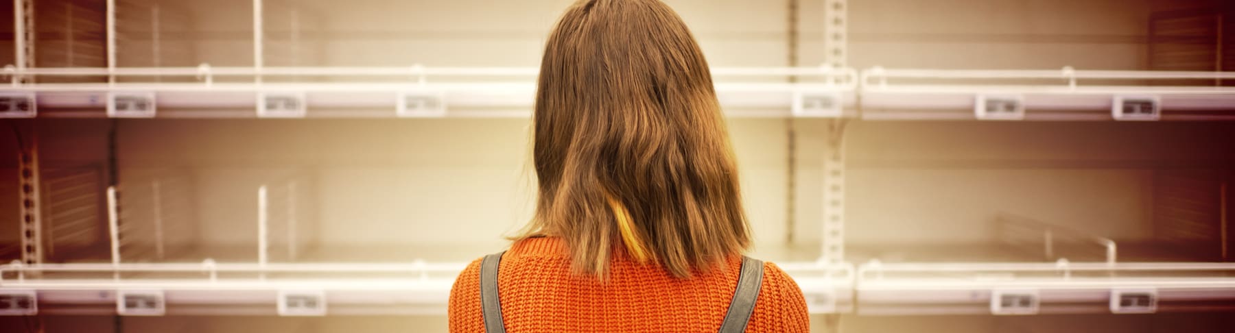 woman looking at empty shelves