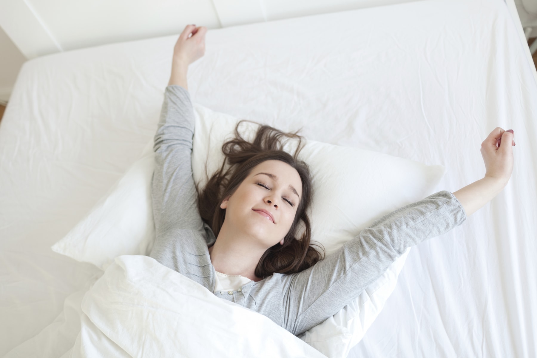 woman stretches on mattress