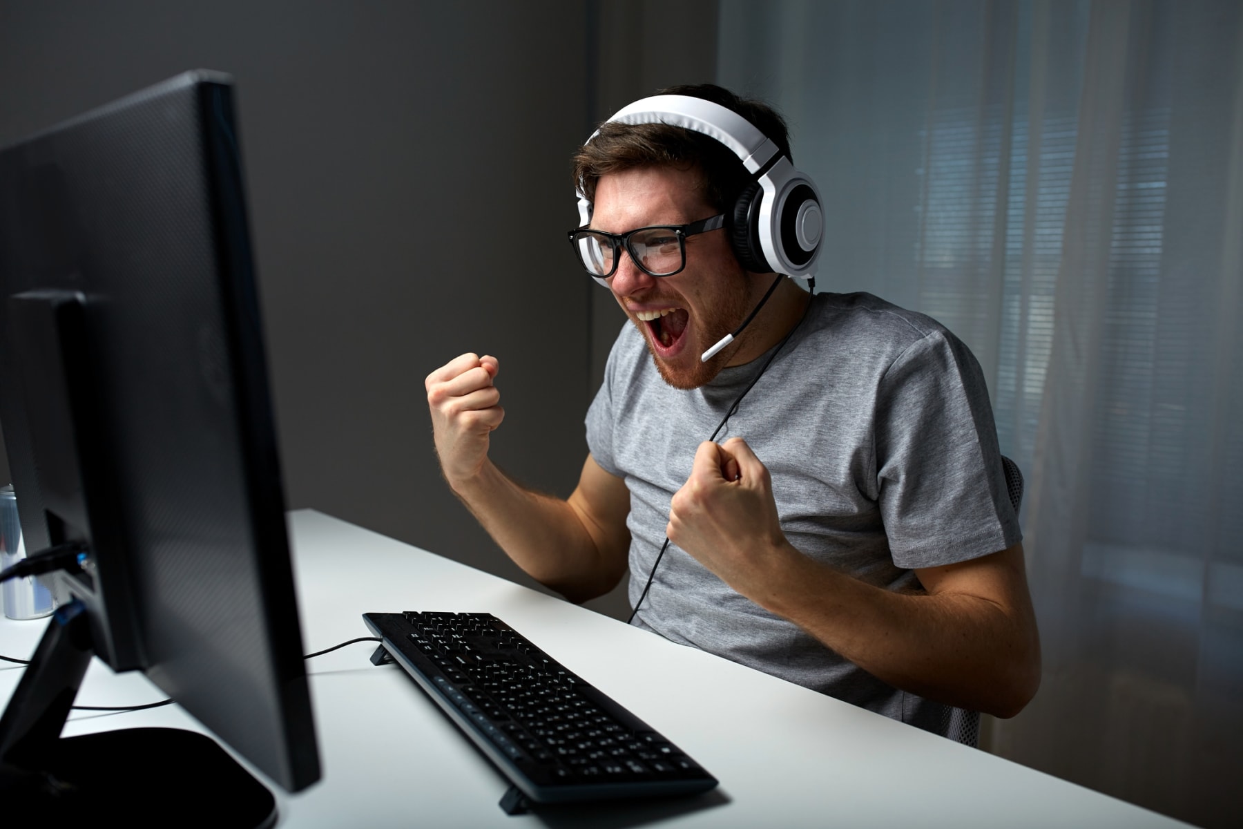 man cheering at computer