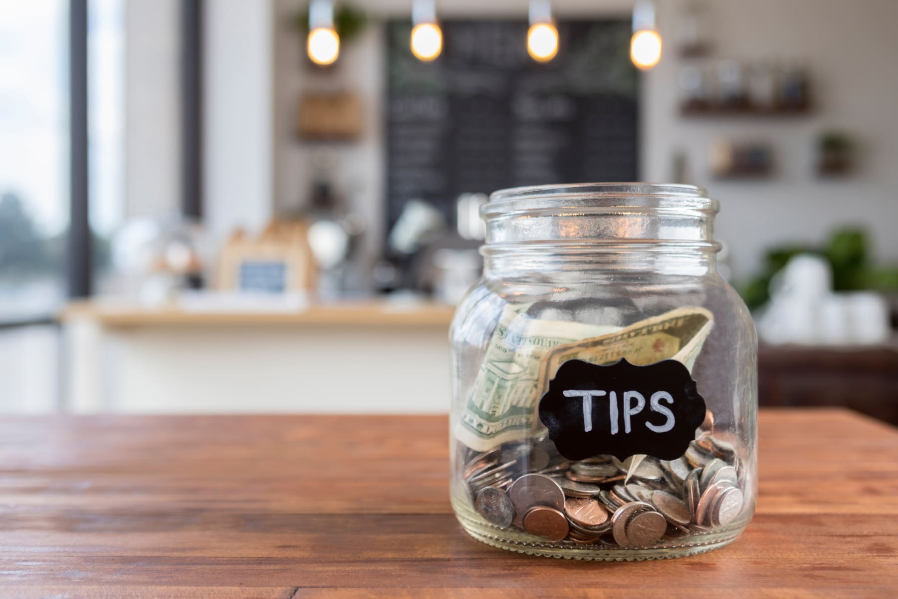 Tips jar on a cafe counter