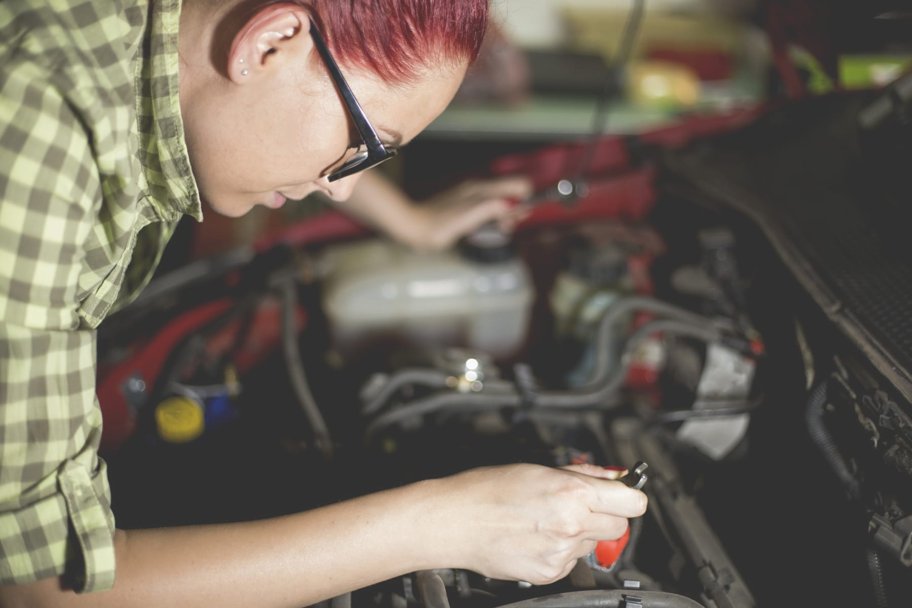 Woman Repairing Car