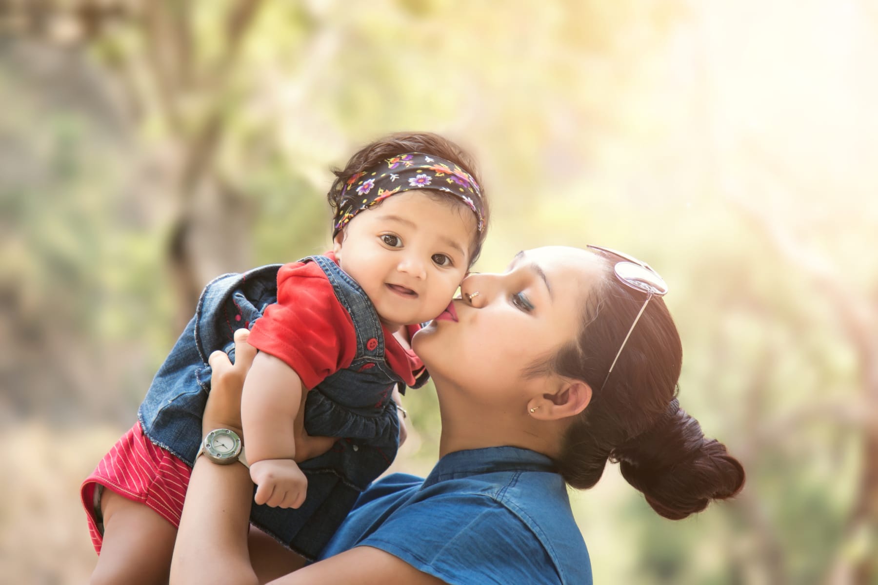 woman kisses baby