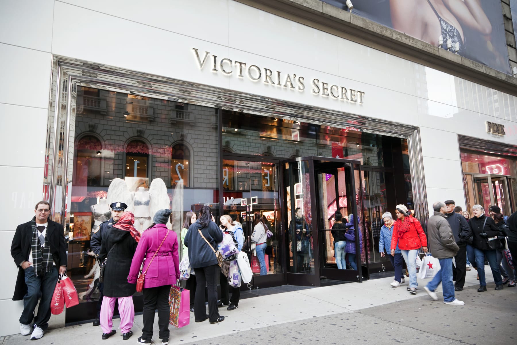 Shoppers stand outside a Victoria's Secret store.