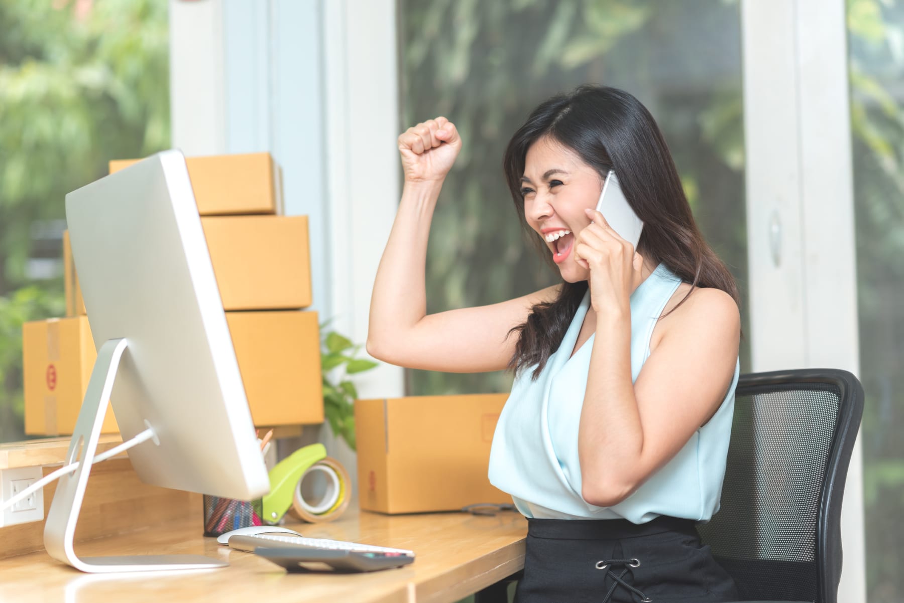 Businesswoman Cheering in Her Home Office