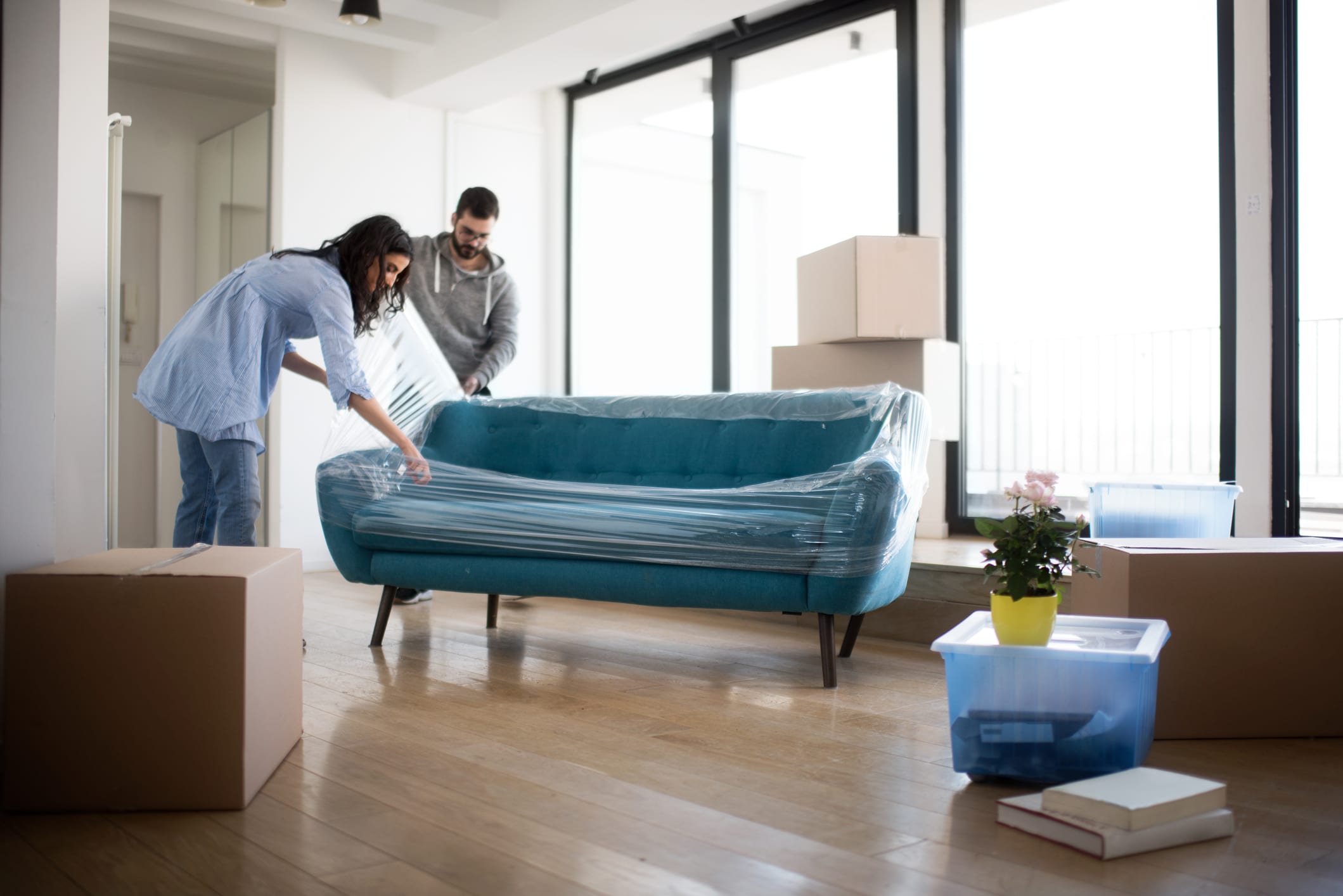 Young Couple Unwrapping a Sofa in Their Apartment