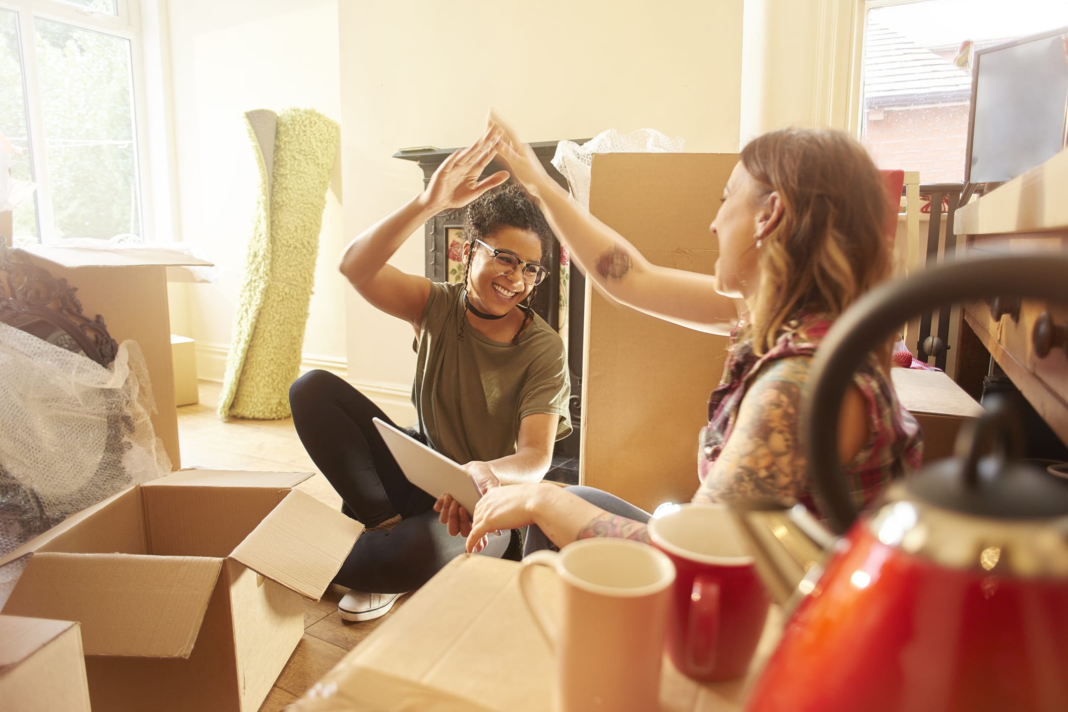 Happy Female Couple Celebrating in New Home
