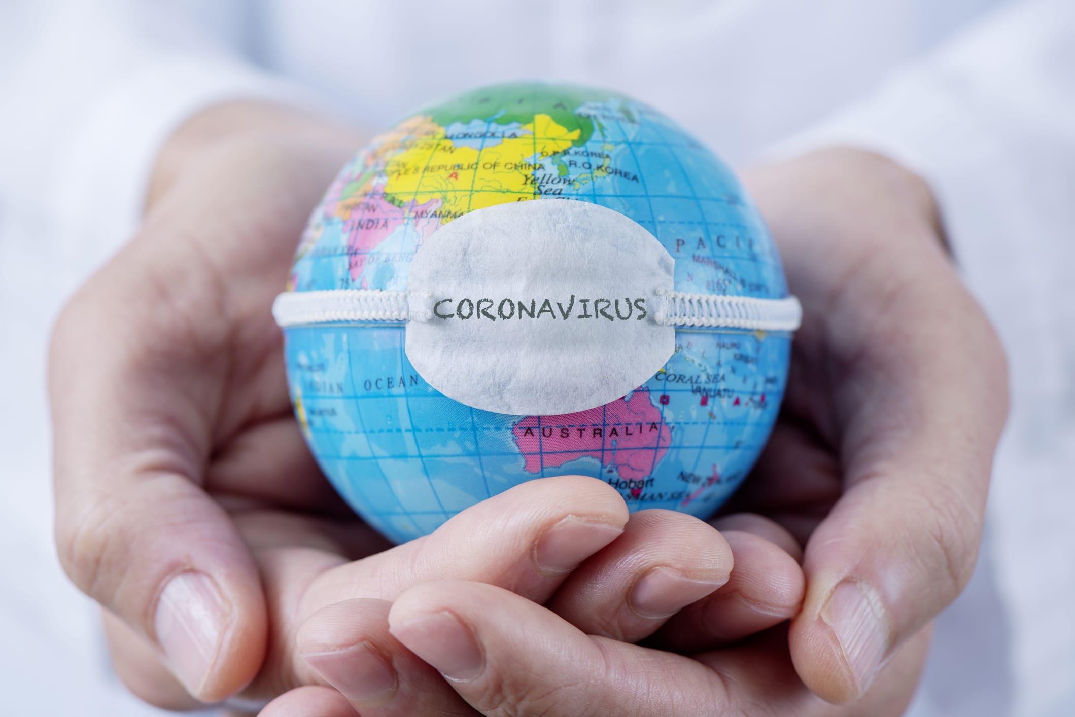 person holding coronavirus globe